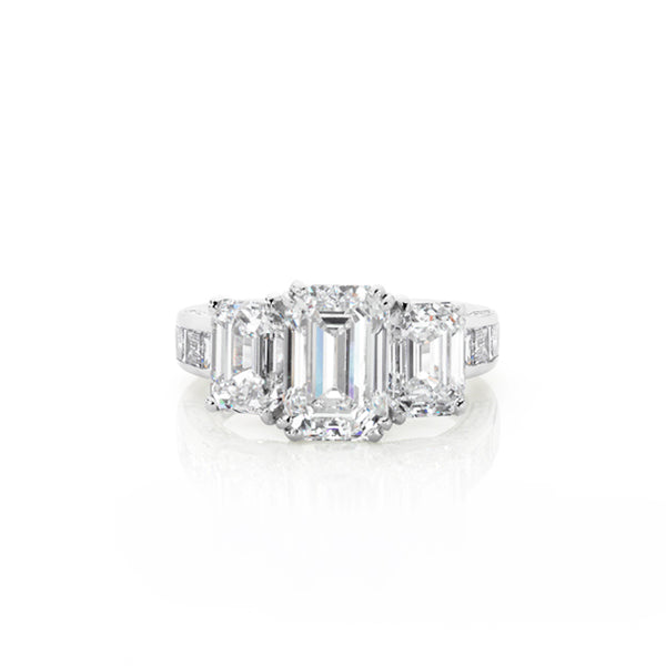 18CT WHITE GOLD THREE STONE EMERALD CUT RING WITH DIAMOND SET BAND (Image 1)