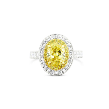 PLATINUM AND 18CT YELLOW GOLD 2.11CT OVAL FANCY INTENSE YELLOW DIAMOND HALO DESIGN RING